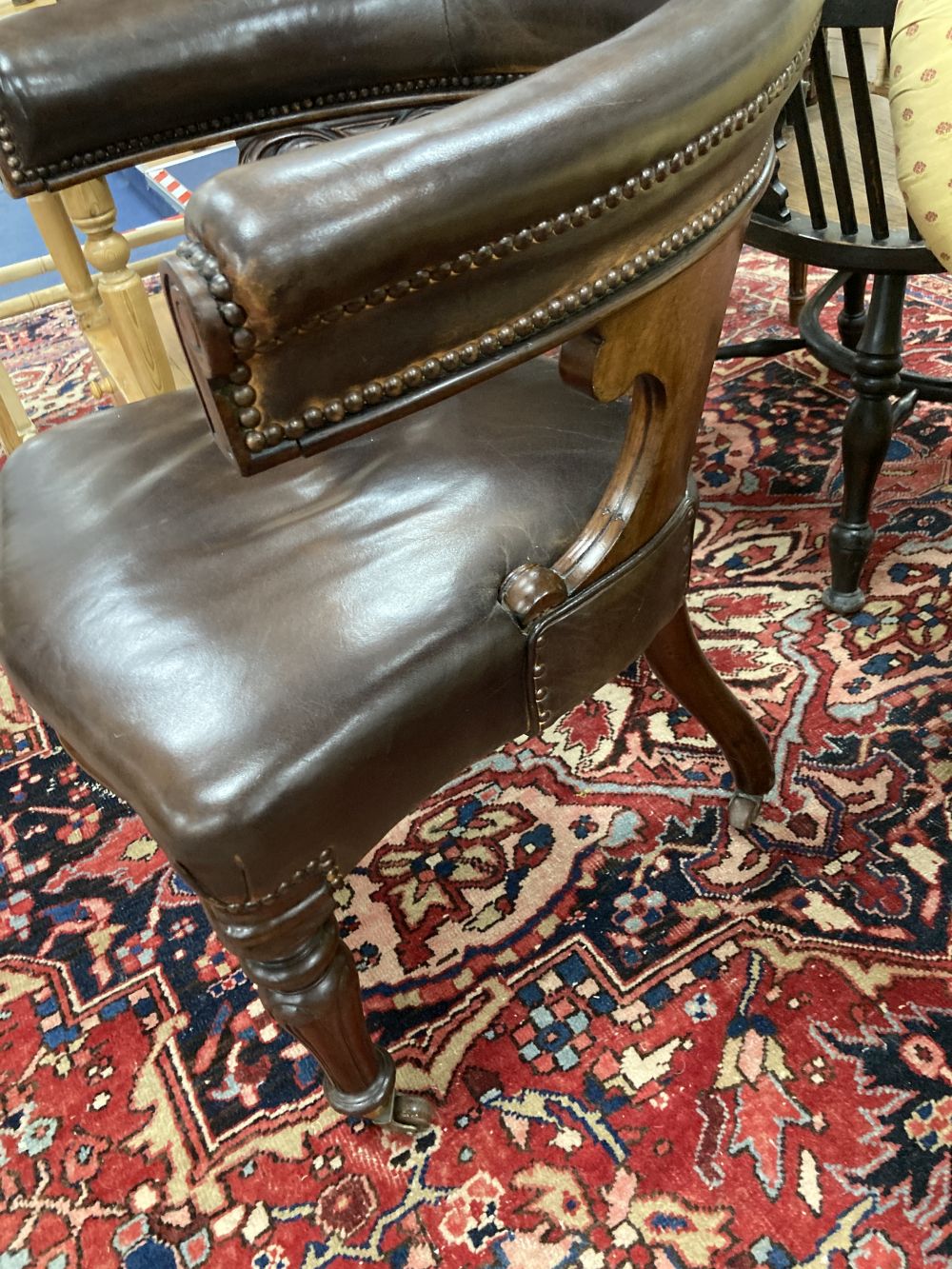 A Victorian mahogany and brown leather library chair